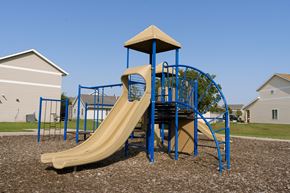 Fargo townhouse for rent - a playground with a slide and a tower. Fargo, ND Bluestem Townhomes