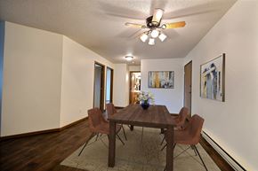 Fargo apartment for rent - Fargo, ND Brownstone Apartments. a dining room with a wooden table and chairs and a ceiling fan