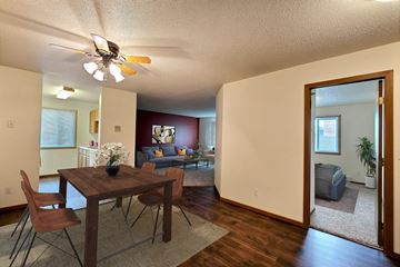 Fargo apartment for rent - a living room and dining room with a table and a ceiling fan