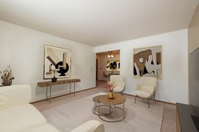 Fargo apartment for rent - Fargo, ND Cambridge Apartments a living room with white furniture and abstract art on the walls