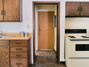 Fargo apartment for rent - a kitchen with a white stove top oven next to a sink