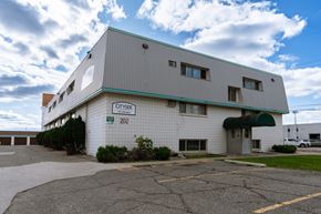 Fargo apartment for rent - a white building with a green roof and a parking lot. Fargo, ND Cityside Apartments