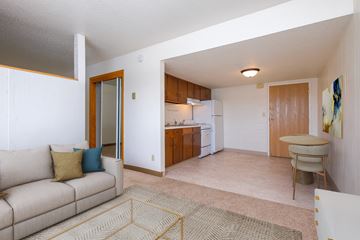 Fargo apartment for rent - a living room and kitchen with a couch and a table