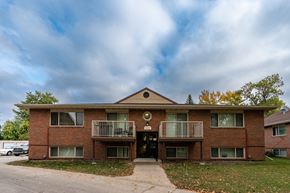 Fargo apartment for rent - an apartment building with two balconies and a sidewalk. Fargo, ND Country Club Apartments.