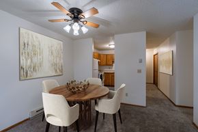 Fargo apartment for rent - a dining room with a table and chairs and a ceiling fan. Fargo, ND Crescent Park Apartments