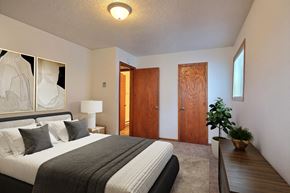 Fargo apartment for rent - Fargo, ND Dakota Manor Apartments. a bedroom with a bed and a desk in a room