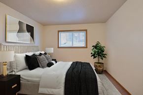 Fargo apartment for rent - Fargo, ND Dakota Manor Apartments. a bedroom with a large bed and a plant in the corner of the room