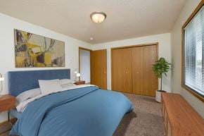 Fargo apartment for rent - Fargo, ND Danbury Apartments. a bedroom with white walls and a blue bedspread