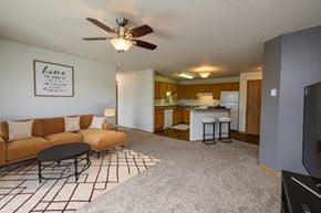 Fargo apartment for rent - Fargo, ND Danbury Apartments. a living room with a couch a table and a ceiling fan