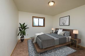 Fargo apartment for rent - Fargo, ND Dynasty Apartments a bedroom with a large bed and a potted plant