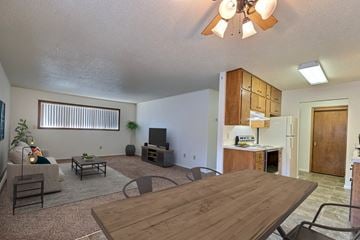 Fargo apartment for rent - an open living room and kitchen with a wooden table