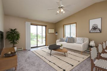 Fargo apartment for rent - a living room with a white couch and a ceiling fan