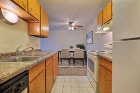 Fargo apartment for rent - a kitchen with wooden cabinets and a dining room in the background at France, North Dakota, 58103