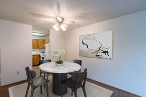 Fargo apartment for rent - a dining room with a table and chairs and a ceiling fan. Fargo, ND Galleria 3 Apartments