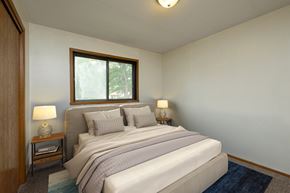 Fargo apartment for rent - Fargo, ND Gemstone Apartments. A bedroom with a bed and two night stands and a window.