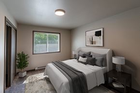 Fargo apartment for rent - a bedroom with a large bed and a window. Fargo, ND Granger Court Apartments