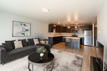Fargo apartment for rent - a living room with a couch and a table in front of a kitchen