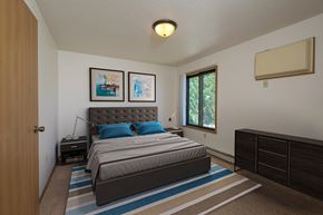 Fargo townhouse for rent - a bedroom with a bed and two dressers. Fargo, ND Hazelwood Townhomes