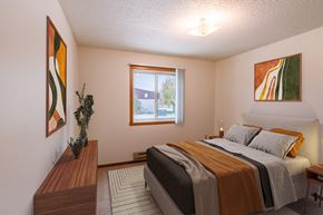 Fargo apartment for rent - a bedroom with a bed and a window. Fargo, ND Huntington Apartments