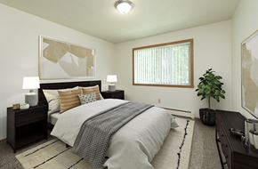 Fargo apartment for rent - Fargo, ND Islander Apartments. A bedrooom with dark wood furnishings such as a bed, night stands, and a dresser. A window brightens the room with natural light