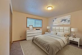 Fargo apartment for rent - a bedroom with a bed and a dresser. Fargo, ND Kennedy Apartments