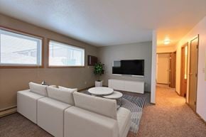 Fargo apartment for rent - a living room with a white couch and a coffee table. Fargo, ND Kennedy Apartments