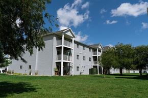 West Fargo apartment for rent - Fargo, ND Lake Crest Apartments. A large apartment complex with a grassy area in front of it