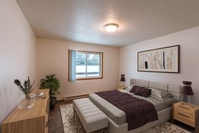 Fargo apartment for rent - a bedroom with a bed and a window. Fargo, ND Long Island Apartments