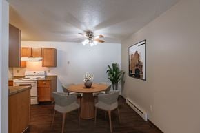 Fargo apartment for rent - a dining area with a table and chairs and a ceiling fan. Fargo, ND Long Island Apartments