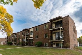 Fargo apartment for rent - A brick apartment building with balconies on a cloudy day. Fargo, ND Long Island Apartments.