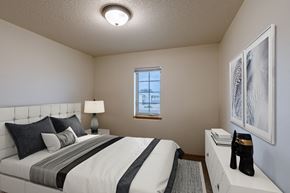 Moorhead townhouse for rent - a bedroom with a large bed and a window. Moorhead, MN Townhomes at Mallard Creek
