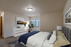Moorhead townhouse for rent - a bedroom with a bed and a dresser and a window. Moorhead, MN Townhomes at Mallard Creek