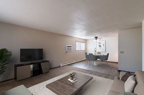 Fargo apartment for rent - a living room with a couch and a table and a tv. Fargo, ND Martha Alice Apartments