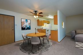 Fargo apartment for rent - a living room with a dining room table and a kitchen. Fargo, ND Maybrook Apartments