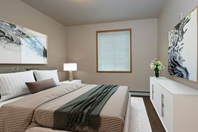 Fargo apartment for rent - a bedroom with a large bed and a window. Fargo, ND North Sky Apartments
