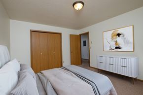 Fargo apartment for rent - Bedroom with a bed and a closet and a door to a bathroom at Oak Court Apartments, Fargo, ND, 58103