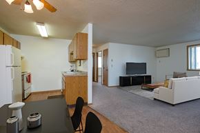Fargo apartment for rent - View of a living room and a kitchen with a couch and a tv, Oak Court Apartments, Fargo, ND 58103