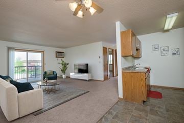Fargo apartment for rent - a living room with a couch and a table and a television