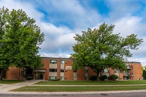 Fargo apartment for rent - Fargo, ND Pacific Park Apartments. An apartment building with trees in front of it