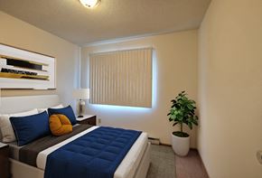Fargo apartment for rent - a bedroom with a large bed and a potted plant. Fargo, ND Pacific South Apartments