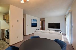 Fargo apartment for rent - a living room with a couch and a table. Fargo, ND Pacific South Apartments