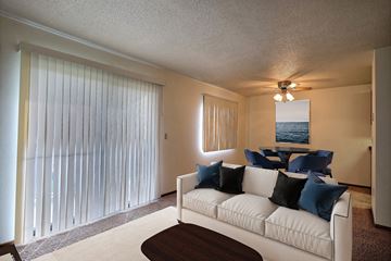 Fargo apartment for rent - a living room with a white couch and a large window