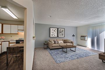 Fargo apartment for rent - an open living room and kitchen with a couch and a table