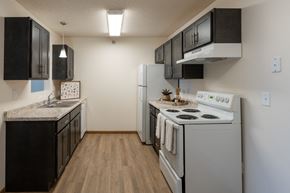 West Fargo apartment for rent - Fargo, ND Parkside Apartments. A kitchen with white appliances and black cabinets