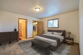West Fargo townhouse for rent - Fargo, ND Parkwest Gardens Apartments.  a bedroom with a bed and a dresser