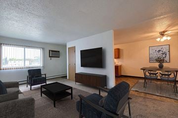 West Fargo townhouse for rent - the living room and dining area of an apartment with a tv