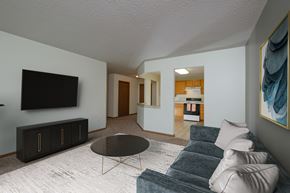 Fargo apartment for rent - A living room with a couch and a coffee table. Fargo, ND Pinehurst Apartments.