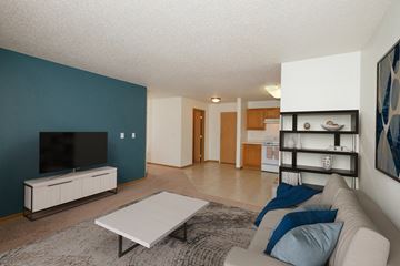 Fargo apartment for rent - a living room with a couch and a coffee table and a television