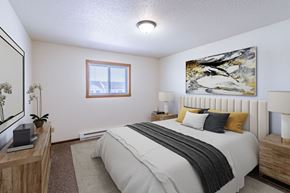Fargo apartment for rent - a bedroom with a bed and a window. Fargo, ND Plumtree Apartments