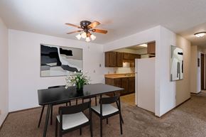 Fargo apartment for rent - a dining area with a table and chairs and a ceiling fan. Fargo, ND Plumtree Apartments